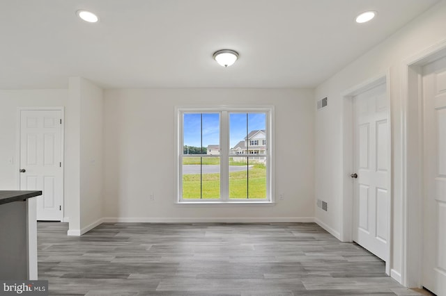 spare room featuring light hardwood / wood-style flooring