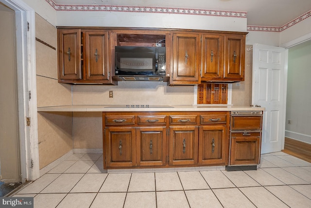 kitchen featuring light tile patterned floors and cooktop