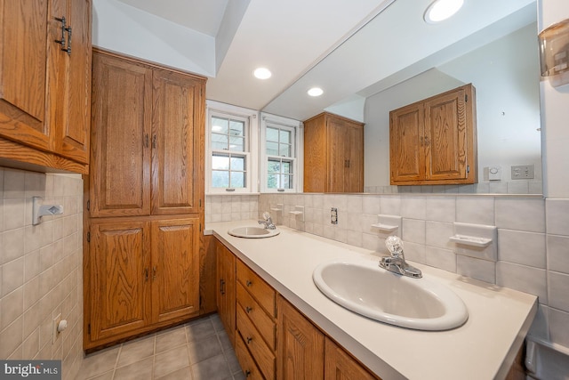 bathroom with tile walls, vanity, and tile patterned floors