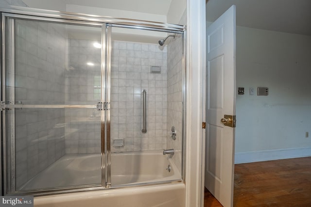 bathroom featuring combined bath / shower with glass door and hardwood / wood-style flooring