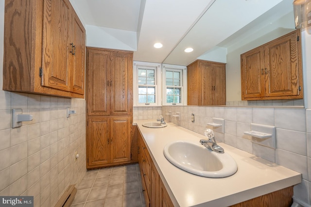 bathroom featuring tile walls, tile patterned flooring, baseboard heating, and vanity