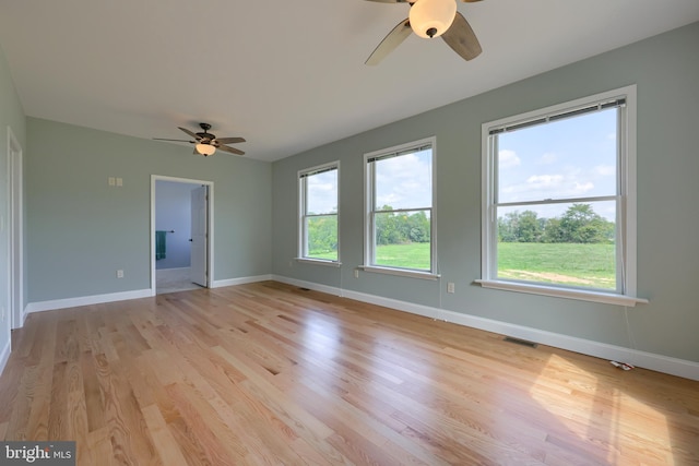 empty room featuring light wood-type flooring and ceiling fan