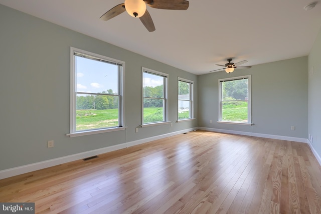 unfurnished room with ceiling fan and light hardwood / wood-style floors