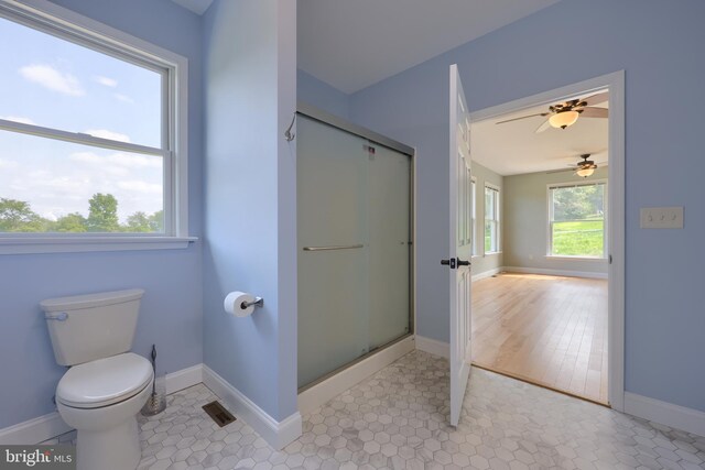 bathroom featuring hardwood / wood-style floors, ceiling fan, toilet, and plenty of natural light