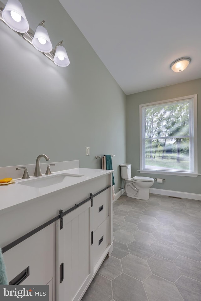 bathroom featuring toilet and vanity