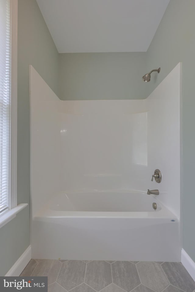 bathroom featuring shower / bath combination and tile patterned flooring