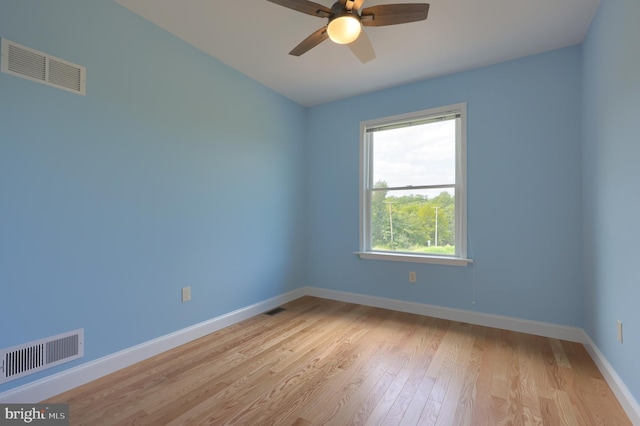 spare room featuring light hardwood / wood-style flooring and ceiling fan