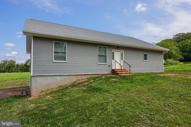 rear view of house featuring a lawn