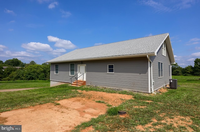 rear view of property with a lawn