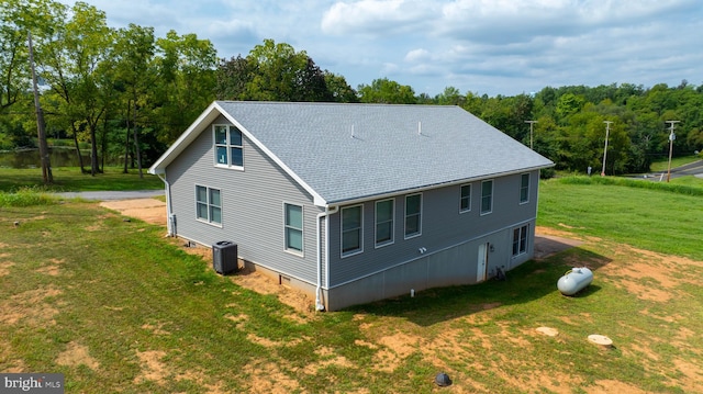 view of home's exterior featuring a yard and central AC unit