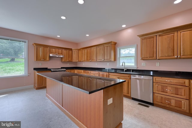 kitchen with appliances with stainless steel finishes, a center island, and sink