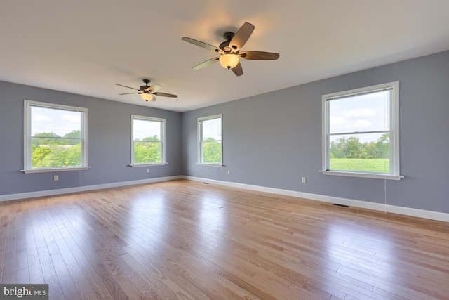 unfurnished room with ceiling fan and light hardwood / wood-style flooring