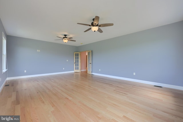 spare room featuring ceiling fan and light hardwood / wood-style floors