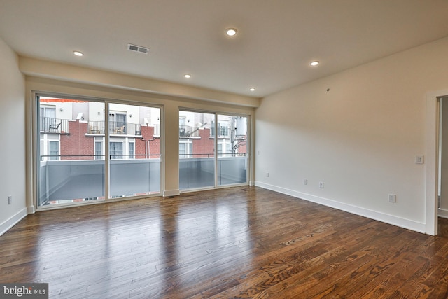 spare room with dark hardwood / wood-style floors