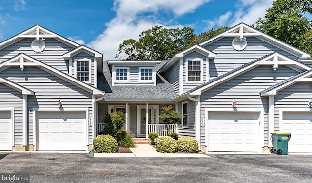 view of front of home featuring a porch and a garage