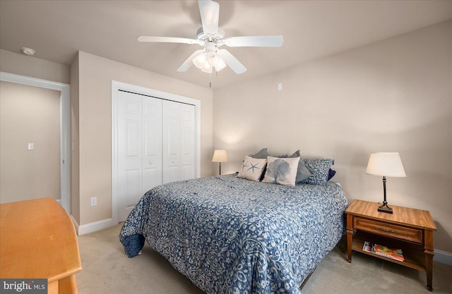 carpeted bedroom with ceiling fan and a closet