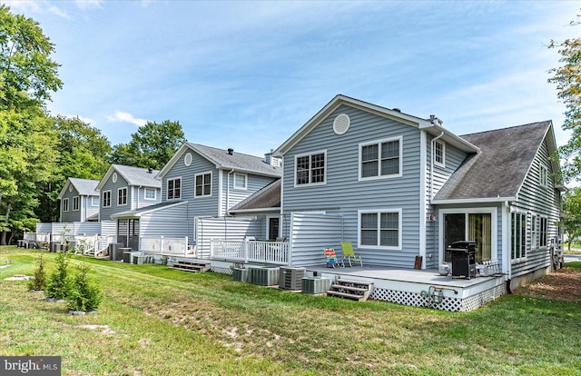 back of property featuring cooling unit, a lawn, and a deck