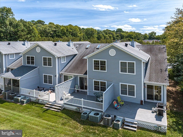 rear view of property with a deck, a lawn, and central AC