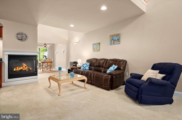 carpeted living room with ceiling fan