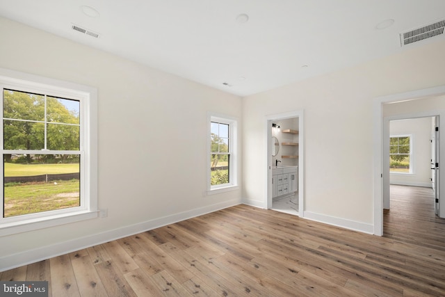 interior space with wood-type flooring and a healthy amount of sunlight