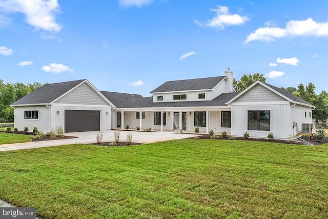 modern inspired farmhouse with central AC unit, an attached garage, driveway, a chimney, and a front yard