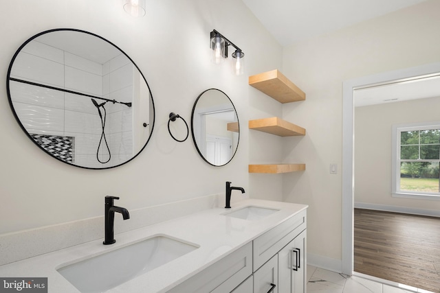 bathroom featuring vanity, a shower, and wood-type flooring