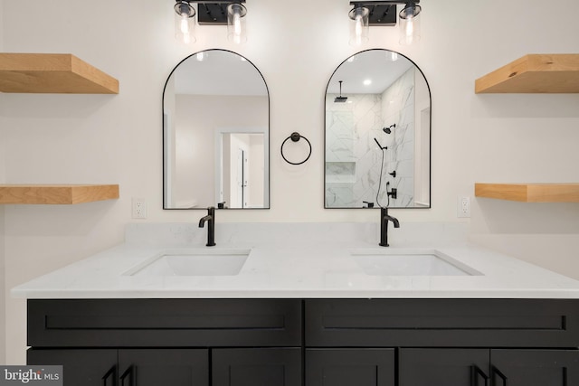 bathroom featuring vanity and tiled shower