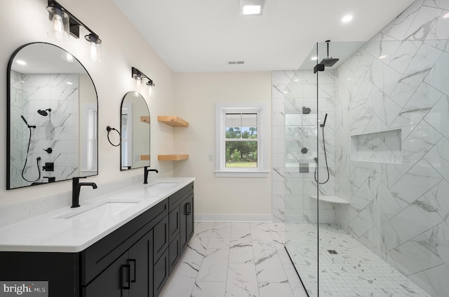 bathroom featuring tiled shower and vanity