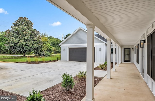 view of patio with a garage and concrete driveway