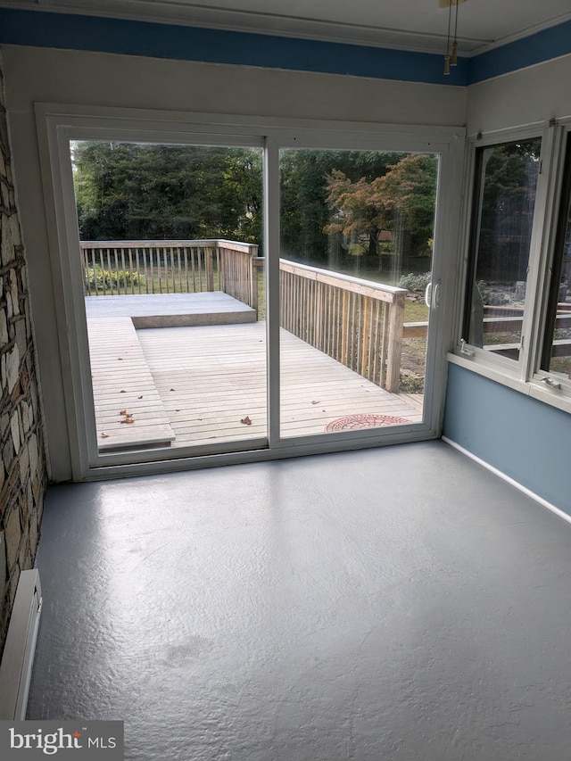 doorway to outside with a baseboard heating unit