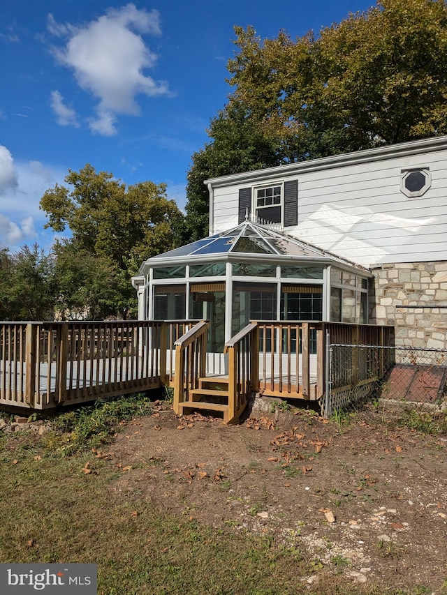 rear view of house featuring a deck