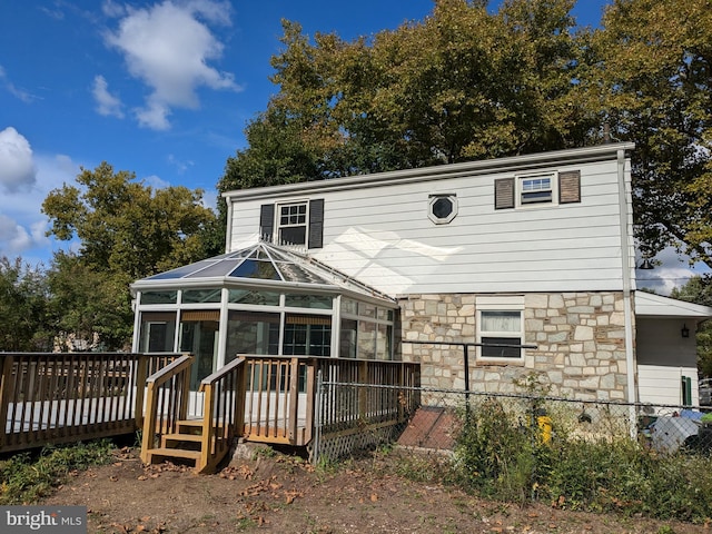 rear view of property with a wooden deck