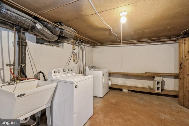 clothes washing area with sink and washing machine and dryer