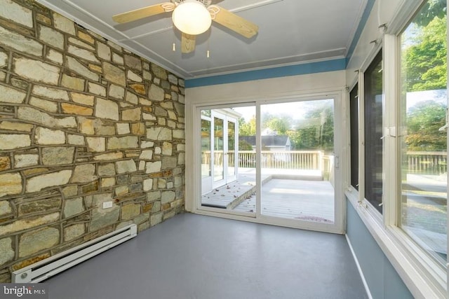 interior space with ceiling fan, baseboard heating, crown molding, and concrete floors