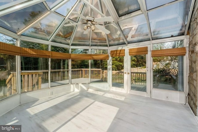 unfurnished sunroom with vaulted ceiling and ceiling fan