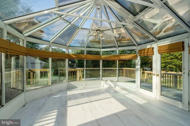 unfurnished sunroom featuring lofted ceiling and ceiling fan