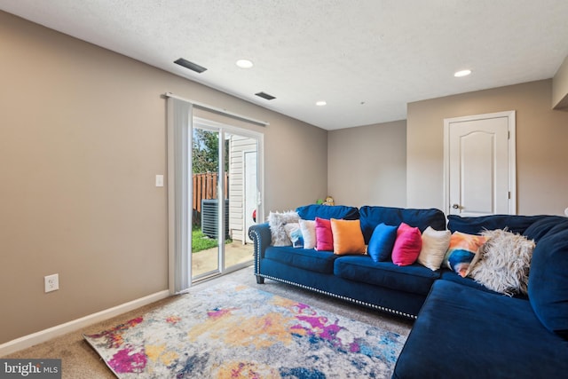 carpeted living room featuring a textured ceiling, recessed lighting, visible vents, and baseboards