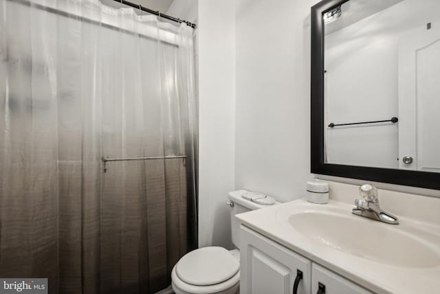 bathroom with vanity, toilet, and a shower with curtain