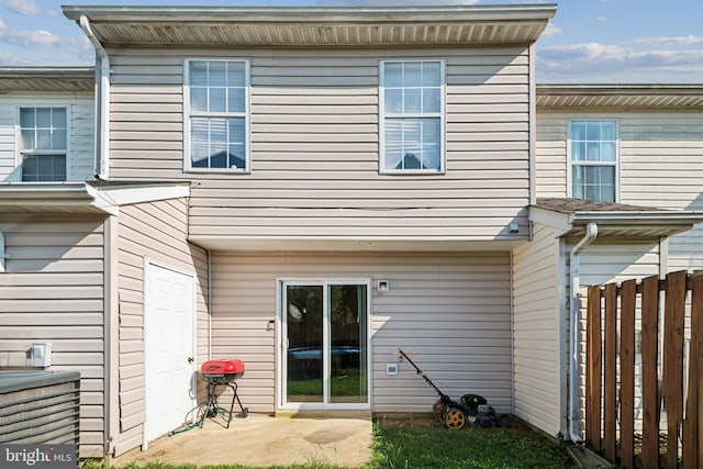 rear view of house featuring a patio area and fence