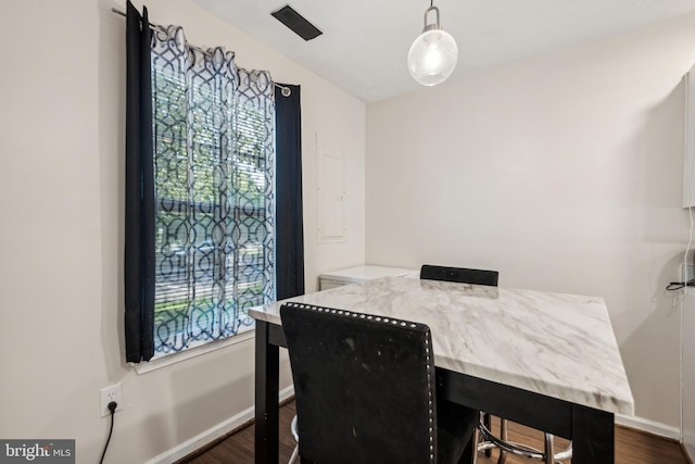 dining area featuring dark wood-style floors and baseboards