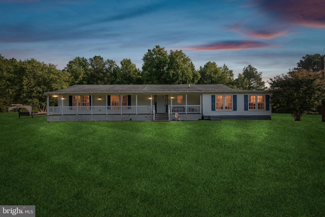 view of front of house featuring a porch and a yard