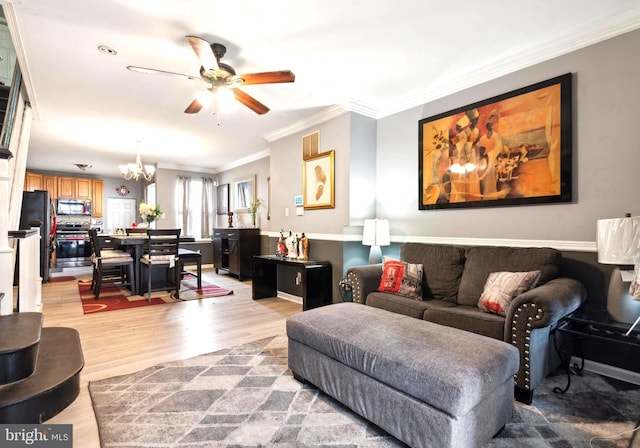 living room with ceiling fan with notable chandelier, crown molding, and hardwood / wood-style flooring