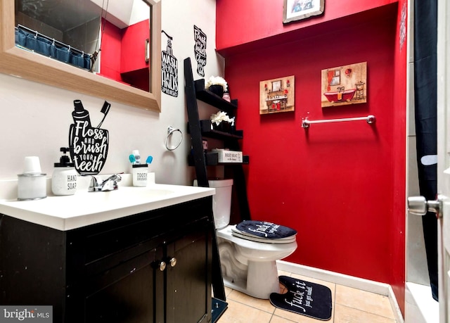 bathroom with curtained shower, tile patterned flooring, toilet, and vanity