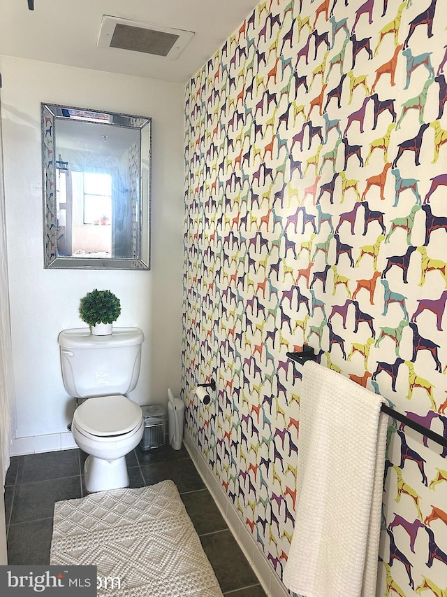 bathroom featuring tile patterned floors and toilet