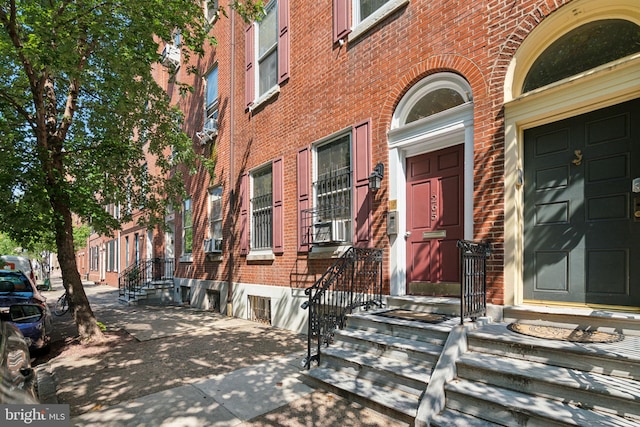 property entrance featuring brick siding