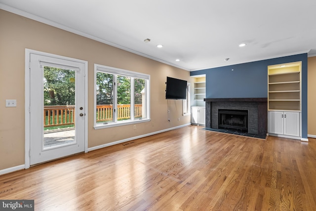 unfurnished living room with wood-type flooring and ornamental molding