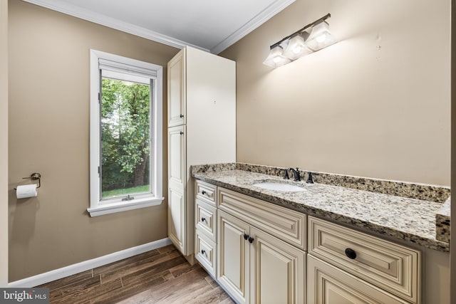 bathroom featuring vanity, wood-type flooring, and ornamental molding