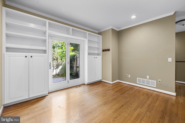 spare room featuring light hardwood / wood-style floors and crown molding