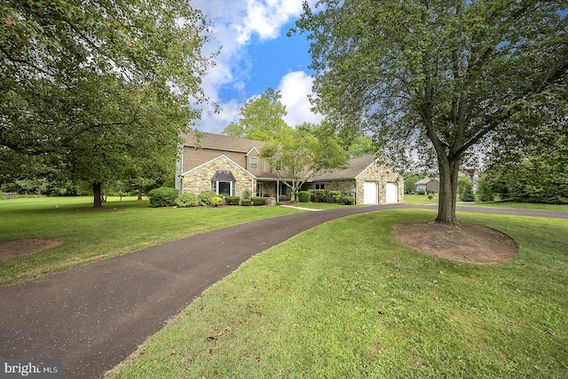 view of front of home with a front yard and a garage