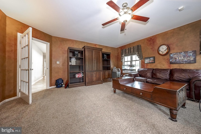 living room featuring ceiling fan and carpet flooring